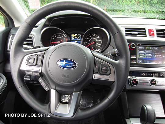 2016 Outback 2.5i base model vinyl wrapped steering wheel, 6.1" audio, and single zone ac/heater buttons