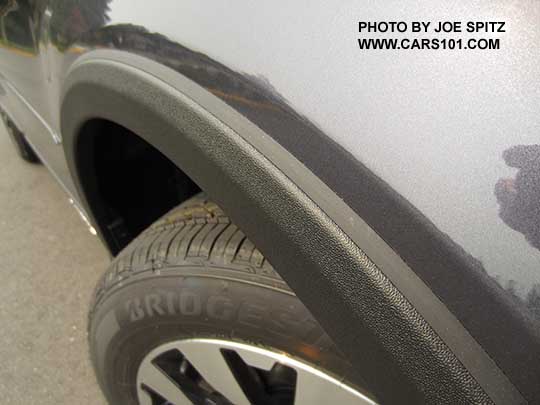 closeup of the 2016 Subaru Outback optional wheel arch molding. Limited shown with 18" alloy wheels