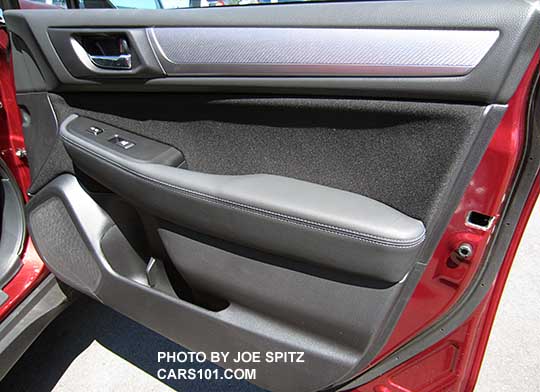 2017 Subaru Outback Premium textured silver door and dash trim, chrome inner door handle. Passenger door shown, venetian red
