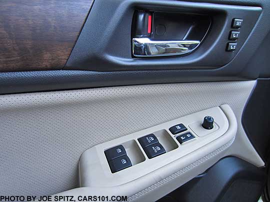 closeup of the 2017 subaru Outback Limited  woodgrain trim, chrome inner door handle, perforated warm ivory leatherette insert, power window/lock buttons with matte gray trim