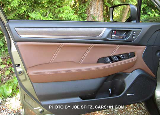 2017 Subaru Outback Touring driver's door inner panel. Java brown ivory stitched leatherette, matte woodgrain and metallic door trim, gloss black power window switch trim, silver tipped power window switches,