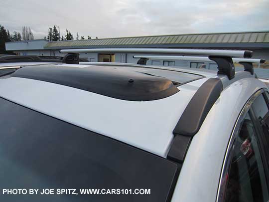 2017 Subaru Outback Touring with optional moonroof air deflector, White car shown.