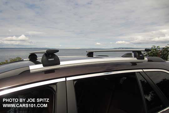 2017 brilliant brown Subaru Outback Touring low profile roof rails, silver with black ends, shown with optional Thule cross bars