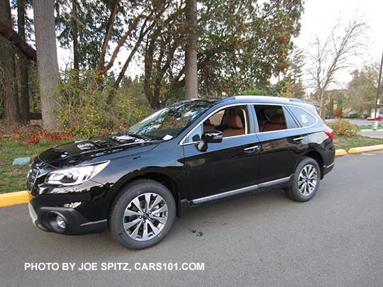 2017 Subaru Outback Touring. Crystal black shown,  with chrome lower trim strip, silver low profile roof rails