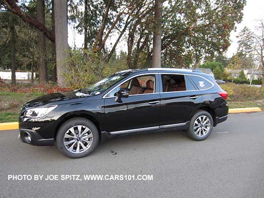 2017 Subaru Outback Touring. Crystal black shown,  with chrome lower trim strip, silver low profile roof rails