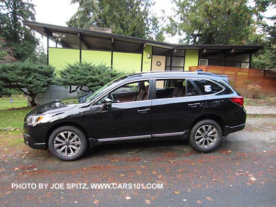 Crystal Black 2017 Subaru Outback Touring with chrome rocker panel trim strip, silver low profile roof rails