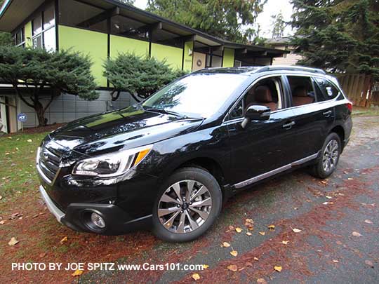 Crystal Black 2017 Subaru Outback Touring with chrome rocker panel trim strip, silver low profile roof rails