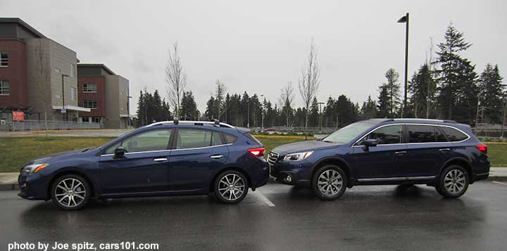 back-to-back 2017 Lapis Blue Subaru  Impreza Limited 5 door and 2017 Outback Touring