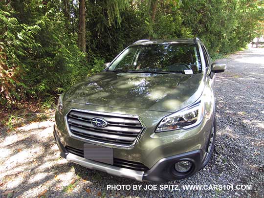 2017 Subaru Outback Touring. Wilderness green shown. Gray front grill, low profile roof rails, chrome trim, front underspoiler