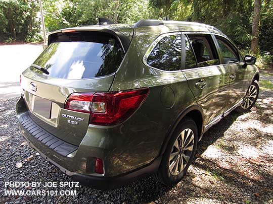 rear view 2017 Subaru Outback 3.6R Touring. Wilderness green shown. Low profile roof rails, chrome trim, optional rear bumper cover, wheel arch moldings