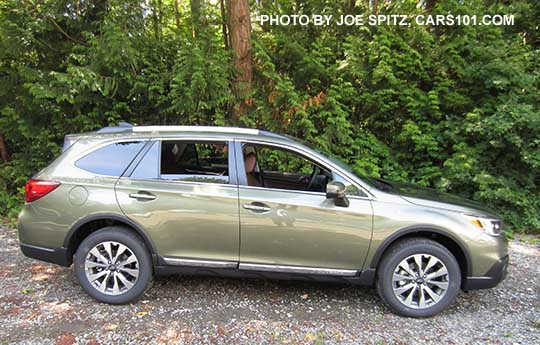 side view 2017 Subaru Outback Touring model. Wilderness green shown. 18" machined silver and gray alloys, Low profile roof rails, chrome trim...