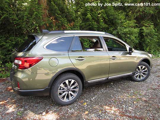 2017 Subaru Outback Touring. Wilderness green shown. Low profile silver roof rails, chrome rocker panel trim, 18" silver and gray  alloys, shown with wheel arch moldings