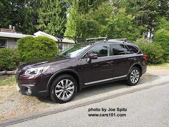 2017 Subaru Outback Touring. Brilliant Brown Pearl color. Standard gray front grill, silver and gray 18" alloys, chrome rocker panel strip and Outback logo, silver low profile roof rails. Shown with optional Thule 460 system aero crossbars, side moldings, wheel arch moldings, splash guards