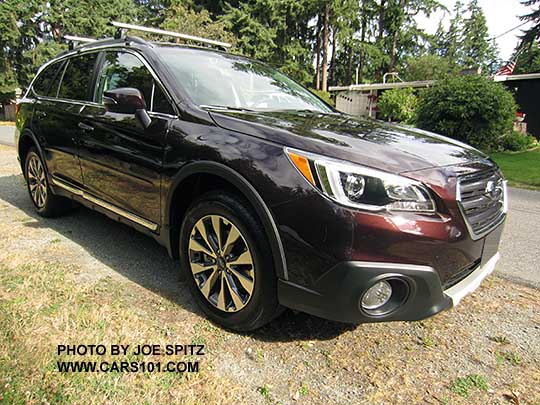 2017 Subaru Outback Touring. Standard gray front grill, silver and gray 18" alloys, chrome rocker panel strip and Outback logo, silver low profile roof rails. Shown with optional Thule crossbars, side moldings, wheel arch moldings, splash guards