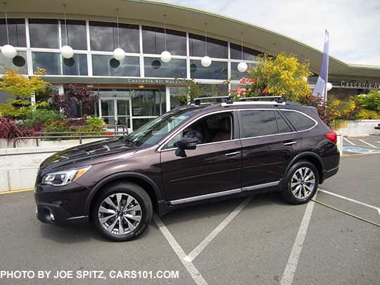 2017 Subaru Outback Touring. Standard gray front grill, silver and gray 18" alloys, chrome rocker panel strip and Outback logo, silver low profile roof rails. Shown with optional Thule 460 system aero crossbars, side moldings, wheel arch moldings, splash guards