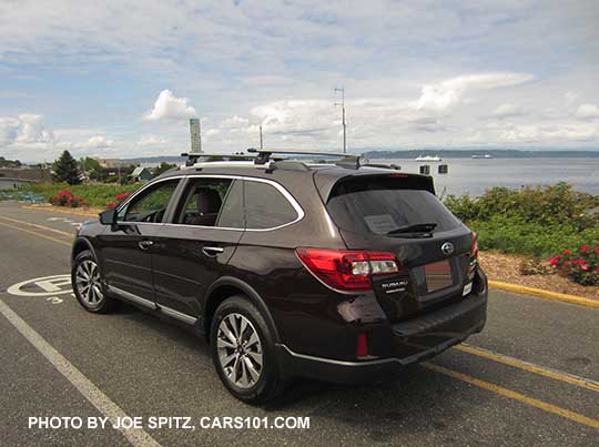 2017 Subaru Outback Touring. Standard gray front grill, silver and gray 18" alloys, chrome rocker panel strip and Outback logo, silver low profile roof rails. Shown with optional Thule roof rails, side moldings, wheel arch moldings, splash guards