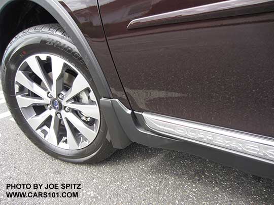 closeup of the 2017 Subaru Outback Touring silver and gray 18" alloys, chrome rocker panel strip and Outback logo. Optional splash guard