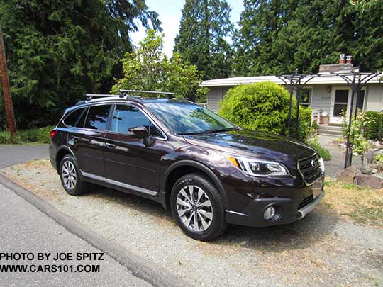 2017 Subaru Outback Touring. Standard gray front grill, silver and gray 18" alloys, chrome rocker panel strip and Outback logo, silver low profile roof rails. Shown with optional Thule roof rails