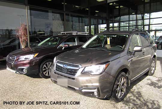 2017 Forester 2.5 Touring, Sephia Bronze color, next to a 2017 Subaru Outback Touring Brilliant Brown color