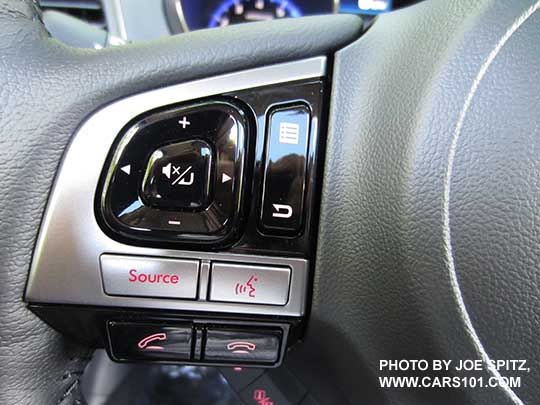 closeup of the 2017 Outback Touring steering wheel gloss black and silver fingertip controls. Left side audio and cell phone bluetooth controls shown.