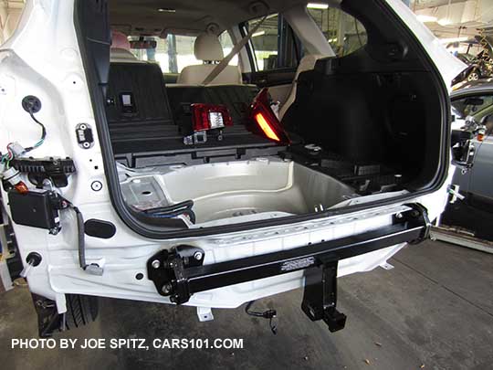 installing a factory 1.25" trailer hitch on a 2017 Subaru Outback. The blind spot detection rear cross traffic alert sensors are the 2 black boxes on the outside corners.