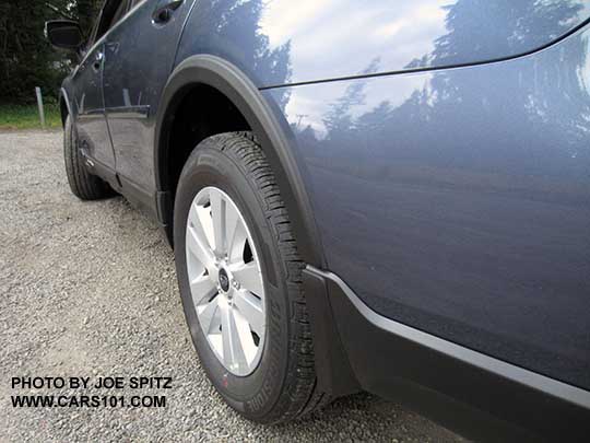 2017 Subaru Outback optional splash guards and wheel arch moldings, rear wheel shown, on a twilight blue 2.5i or Premium model with silver alloys