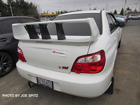 2005 STI with Subaru's 2016 'I heart My Subaru' sticker on the trunk. Its an aftermarket spoiler