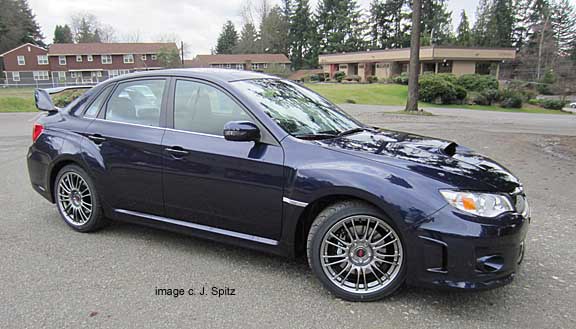 side view of subaru sti limited sedan, plasma blue pearl color