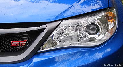 closeup of sti headlight with silver surround, new for 2012