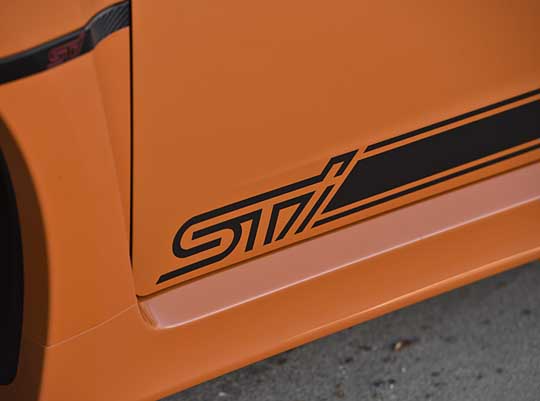 Tangerine orange limited edition 2013 STI 4 door sedan, available spring 2013, black graphics shown