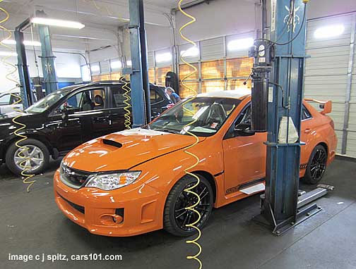 in the shop- a brand new tangerine orange 2013 subaru impreza sti special edition. 1 of only 100 made