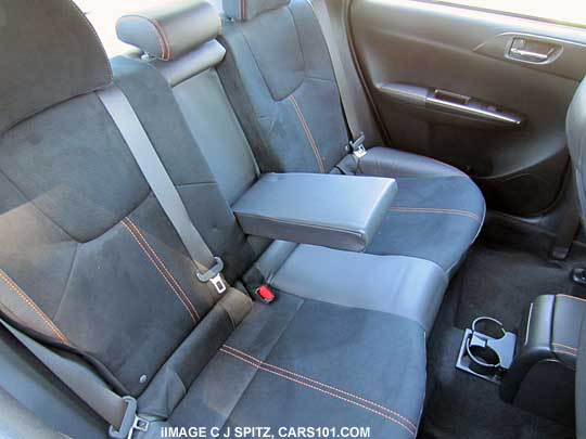 rear seat of 2013 subaru sti special edition sedan with armrest,  cupholder in center console