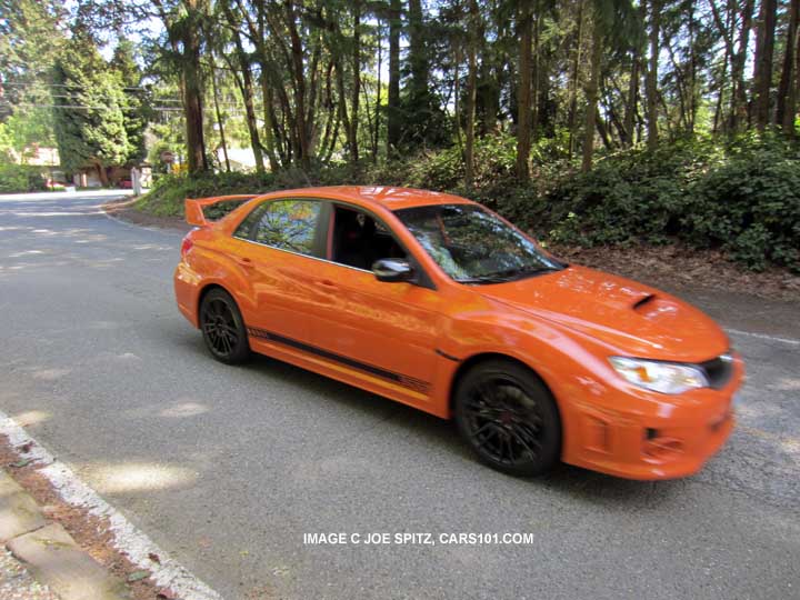 going down the road- 2013 subaru impreza wrx sti se special edition limited production tangerine orange 4 door sedan