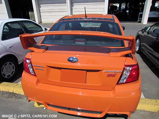 spoiler  and rear vortex generator on n2013 subaru sti special edition tangerine orange sedan