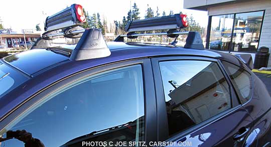 close-up of the 5 door WRX with factory crossbars and ski attachments, plasma blue shown