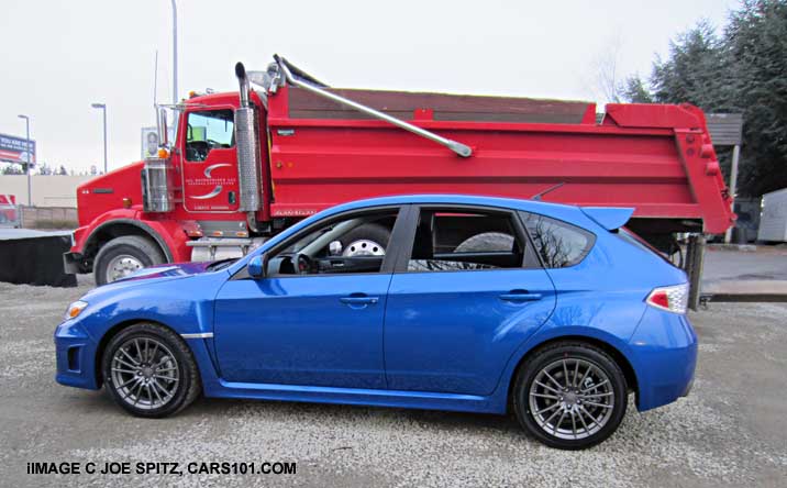 2014 subaru wrx 5 door by a dump truck