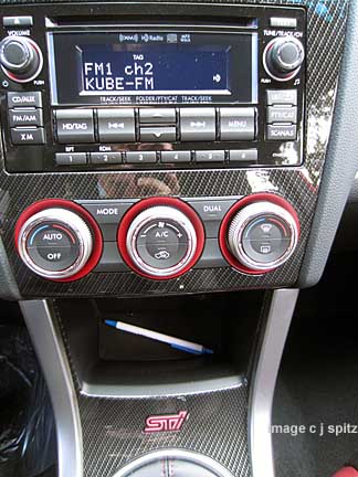 2015 STI console with red lit climate control knobs