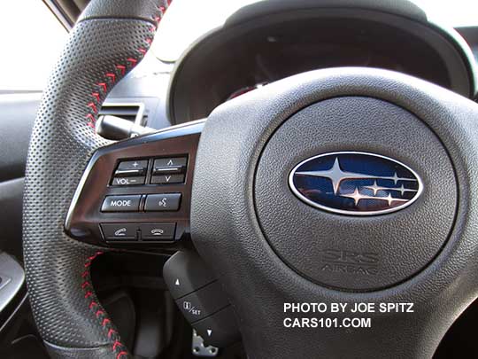 closeup of the 2015 WRX STI leather wrapped steering wheel with red stitching, dimpled hand grips
