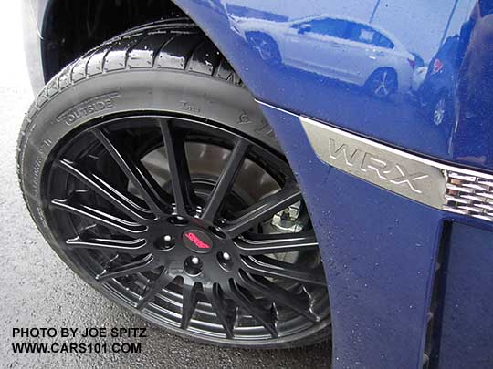 optional 18" black STI alloy wheel, part of the optional 2017 and 2016 WRX Sport Package on a lapis blue WRX