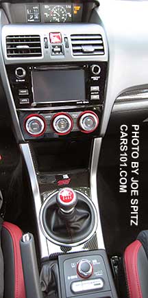2016 STI center console with DCCD/SI drive control, shifter with red pattern, climate control knobs, 6.2" audio screen, on top is the trip computer showing boost gauge