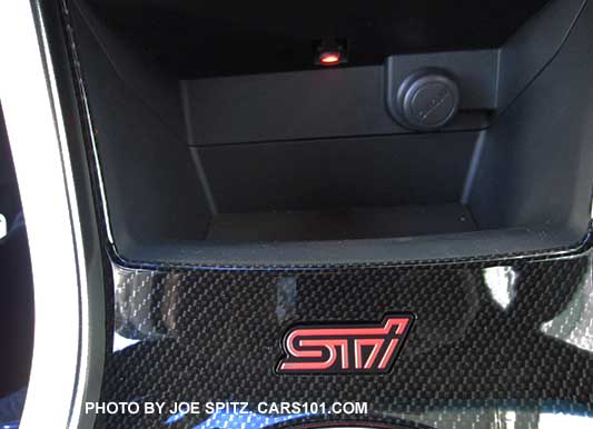 2016 STI center console storage bin with Illuminated red STI logo, and small light and 12v outlet inside the storage bin