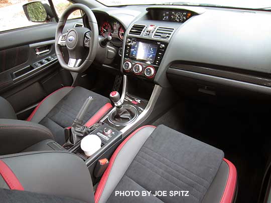 2016 Subaru STI interior, from the passenger side. black alcantara, plastic carbon dash trim, 6.2" audio system