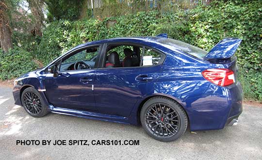 2016 Subaru Impreza WRX STI has 18" gray alloy wheels, tall rear spoiler, lapis blue shown
