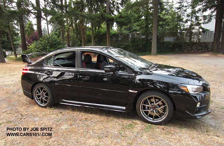 side view 2016 Subaru WRX STI Limited, tall spoiler, crystal black, optional body side moldings, rear aero splash guards