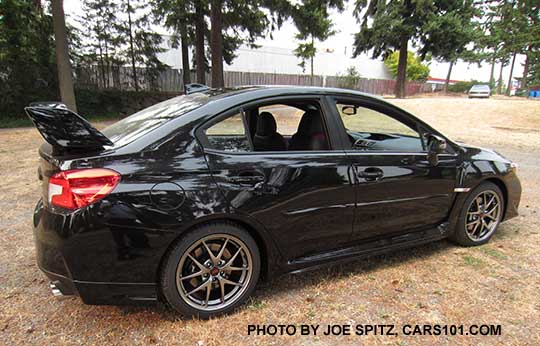 2016 STI Limited, with optional body side moldings and rear aero splash guards. Tall spoiler. Crystal black color.