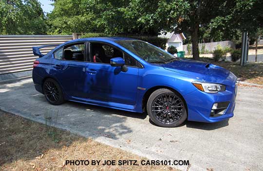 side view world rally blue 2016 WRX STI, tall rear spoiler, 18" gray multi-spoke alloys