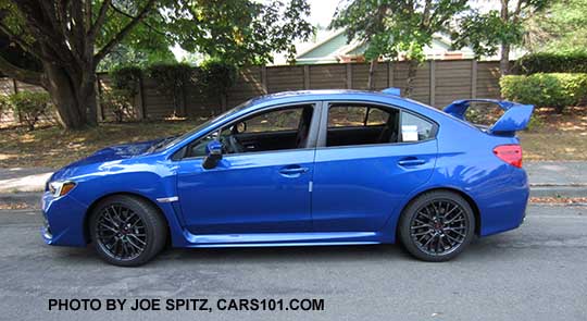 2016 Subaru WRX STI side view, WRX blue shown, tall spoiler, gray alloys 18"