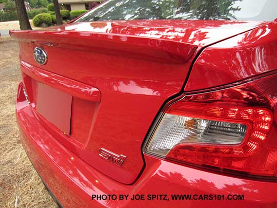 close-up of the new for 2016, Pure Red color WRX STI Limited with small trunk lip spoiler