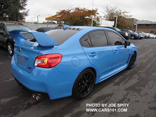2016 WRX STI Hyperblue with vortex generator on the roof, and aftermarket dark tinted windows