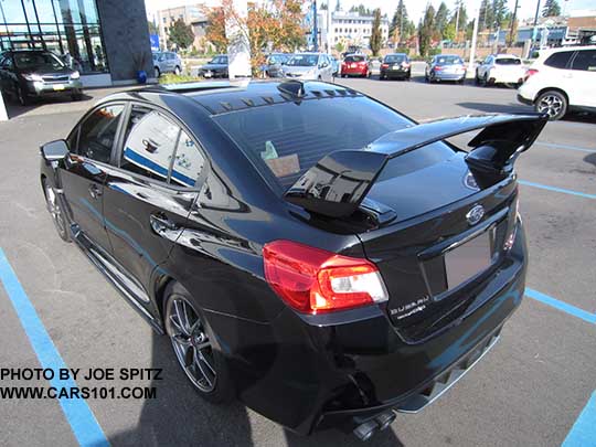 Black STI with optional roof mounted vortex generator, aftermarket tinted windows